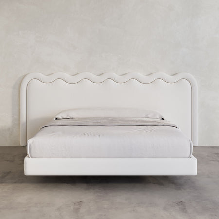 Extra wide Bondi Bed Frame in white linen against micro cement wall