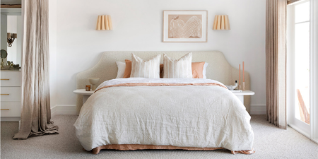 Boucle bed head in all white master bedroom with peach linen sheets and big windows