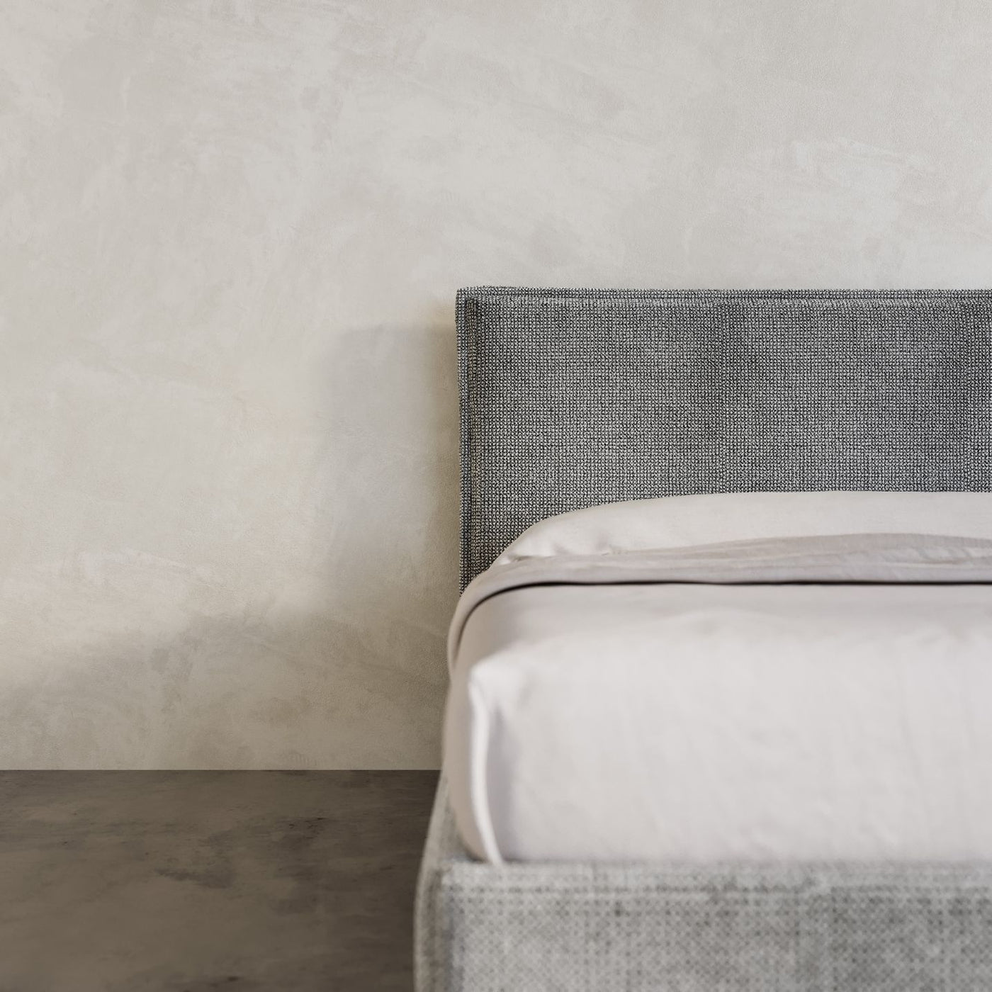 Stockholm Bed Frame in a chunky grey Wool Fabric pictured in a high end room with micro cement walls