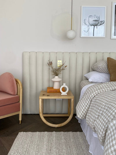 Extra wide panelled bed head in master bedroom. Upholstered in white boucle