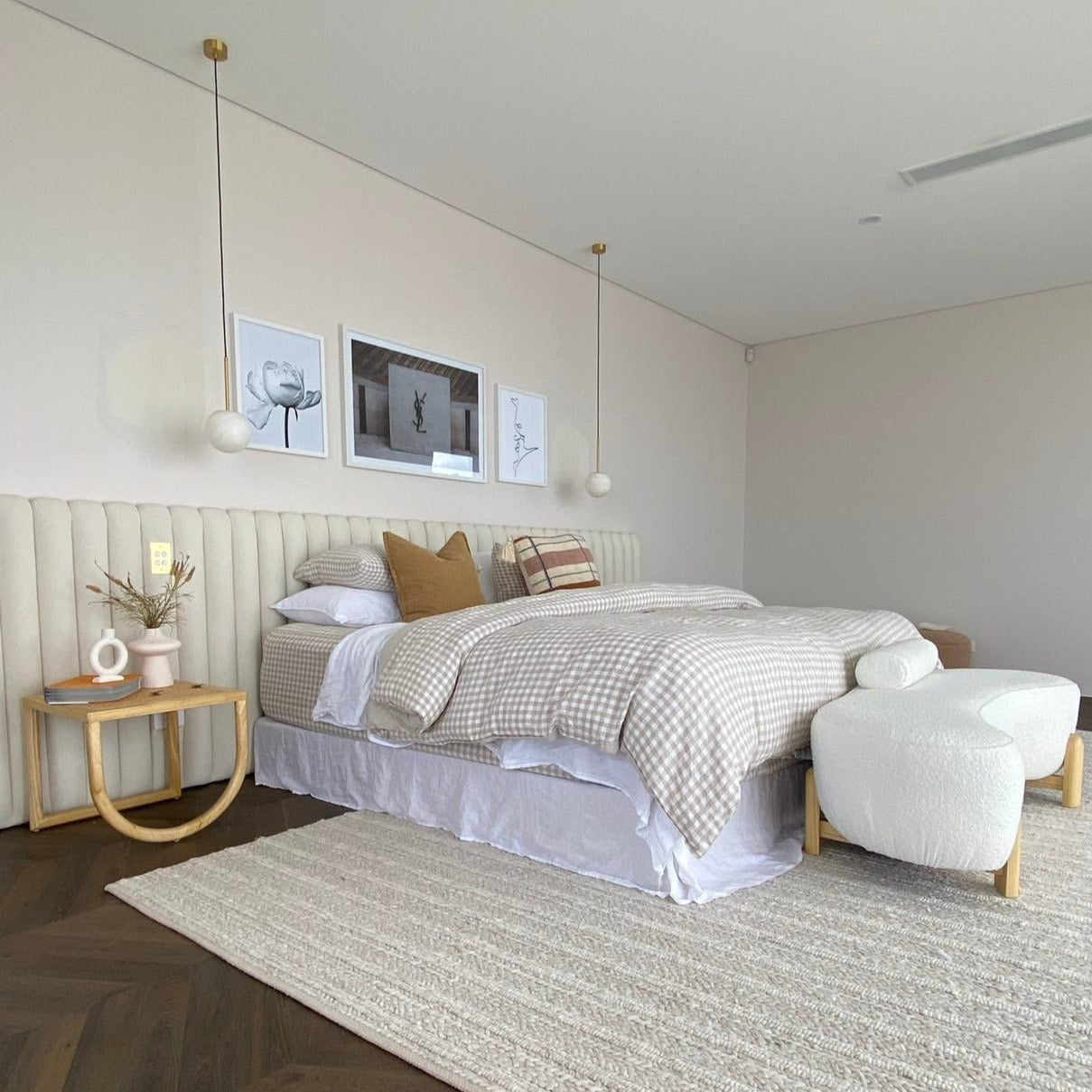 Extra wide panelled bed head in master bedroom. Upholstered in white boucle