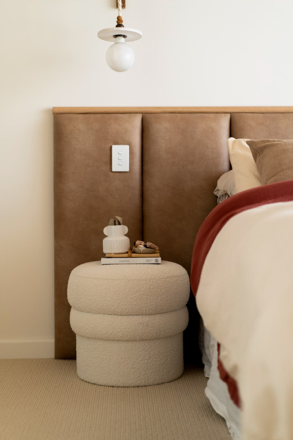 Leather look panelled bed head in master bedroom with timber feature strip and sheers drapes to the side