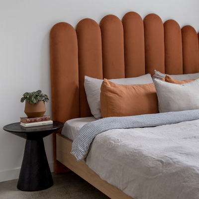 Velvet Bed Head in Terracotta Velvet pictured with a black bedside table. Made in QLD by Create Estate
