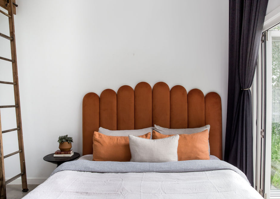 Velvet Bed Head in Terracotta Velvet pictured with a black bedside table. Made in QLD by Create Estate