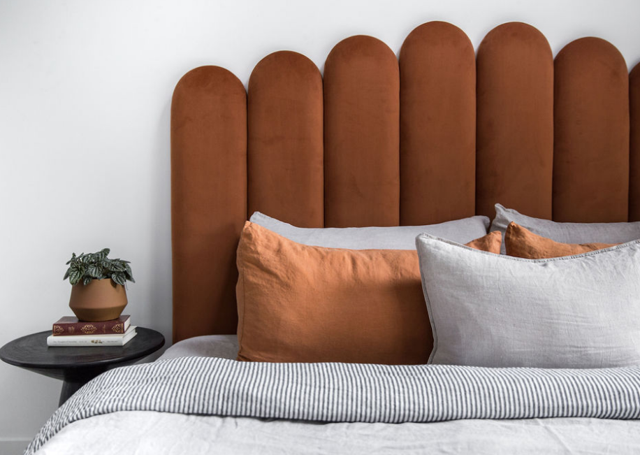 Velvet Bed Head in Terracotta Velvet pictured with a black bedside table. Made in QLD by Create Estate